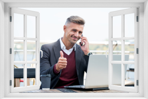 Technology as business necessity. Businessman show thumbs up. Man use mobile and computer technology. New technology. Modern life. Business communication. Technology approved by professionals