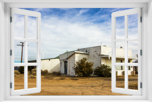 Fototapeta Naklejka Na Ścianę Okno 3D - Damaged Building In Depressed High Desert Town