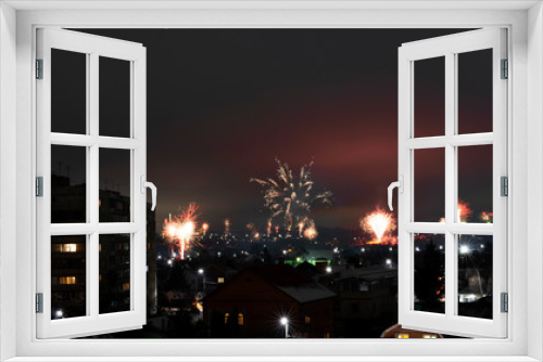 Fototapeta Naklejka Na Ścianę Okno 3D - Night cityscape with lots of exploding holiday fireworks.
