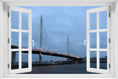 Fototapeta Naklejka Na Ścianę Okno 3D - Modern bridge on Krestovsky island in St. Petersburg. City landscape. December 30, 2019. Cable-stayed bridge at dusk. Highlighting the city bridge.