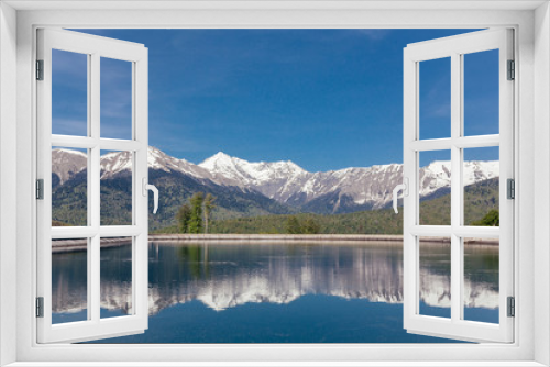 Fototapeta Naklejka Na Ścianę Okno 3D - Stunning picturesque landscape of a mountain lake against the backdrop of mountains and blue sky on a sunny warm summer day. The concept of travel and nature reserves. Copyspace