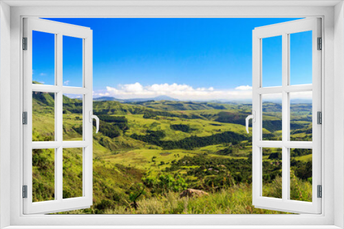 Fototapeta Naklejka Na Ścianę Okno 3D - Panorama of a some mountains and a green and vast valley on a sunny day, Drakensberg, Giants Castle Game Reserve, South Africa