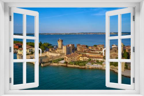 Fototapeta Naklejka Na Ścianę Okno 3D - Unique view. Aerial photography, the city of Sirmione on Lake Garda north of Italy. In the background is the Alps. Resort place. Aerial view.