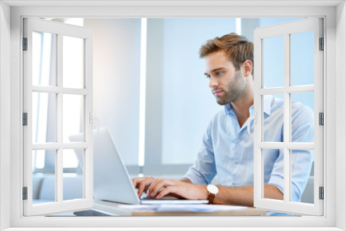 Young business entrepreneur working on his laptop computer