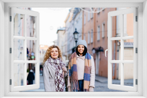 I have so much to tell you Two beautiful young women walking along the street and talking