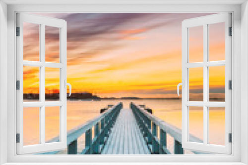 Fototapeta Naklejka Na Ścianę Okno 3D - Old Frosted Wooden Boards Pier On Calm Water Of Lake Or River Or Sea At Evening Or Morning Time. Sunset Sunrise In Winter Season