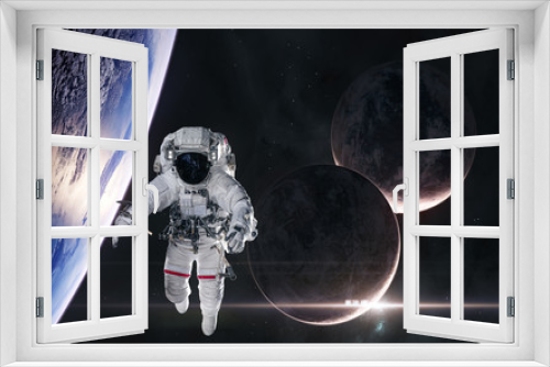 Fototapeta Naklejka Na Ścianę Okno 3D - Astronaut in orbit of planet in deep space. Rising star. Science fiction. Elements of this image furnished by NASA
