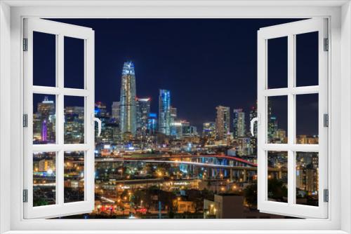 Fototapeta Naklejka Na Ścianę Okno 3D - San Francisco skyline night view with city lights, the Bay Bridge and trail lights