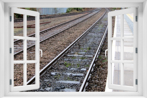 Fototapeta Naklejka Na Ścianę Okno 3D - The Train Track Leaving a Rural Railway Station.