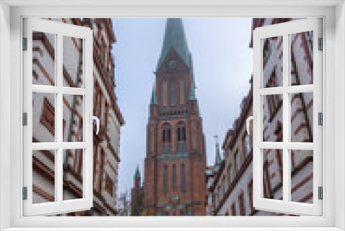 Fototapeta Naklejka Na Ścianę Okno 3D - Clock tower of Schwerin Cathedral with fog in the morning