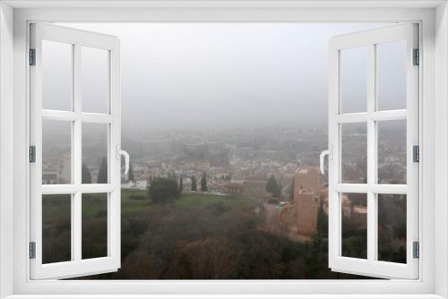 aerial view of the city Granada in the mroning fog from Alhambra citadel