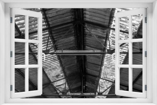Fototapeta Naklejka Na Ścianę Okno 3D - A corrugated iron vaulted ceiling in an industrial setting