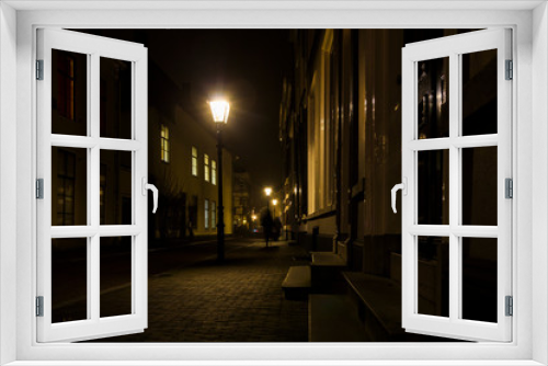 Fototapeta Naklejka Na Ścianę Okno 3D -  Utrecht, Netherlands, January 21st, 2020.. Misty Evening, night view of street, old dutch houses, pedestrian, bicycles along the street.
