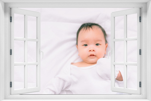 Smiling baby boy lying on a  white bed, Family morning at home,Children hygiene.