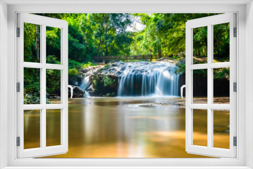 Fototapeta Naklejka Na Ścianę Okno 3D - Beautiful waterfall Mae Sa, Thailand. Fresh and pure water stream is flowing on the rock stone ground in tropical rainforest. Fresh plants and trees above river. Vibrant colors in pure nature