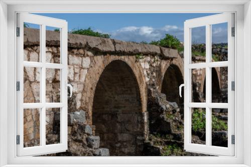 Fototapeta Naklejka Na Ścianę Okno 3D - ruins of the old fortress with perspective arched walk-through ways covered with green plants