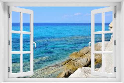 Fototapeta Naklejka Na Ścianę Okno 3D - Seascape of rocky beach with azure sea water in sunny day. Amazing natural beach with white stones and turquoise water. crystal clear sea with sun reflection. Halkidiki Greece Blue Flag Beach
