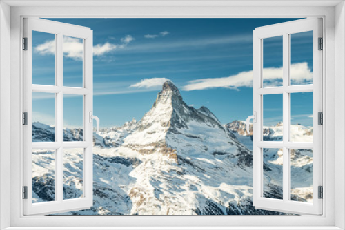 Fototapeta Naklejka Na Ścianę Okno 3D - Scenic view on snowy Matterhorn (Cervin, Cervino) peak in sunny day with blue sky, pine trees, valley and clouds in background. Panoramic landscape in white and blue colors in Zermatt, Switzerland