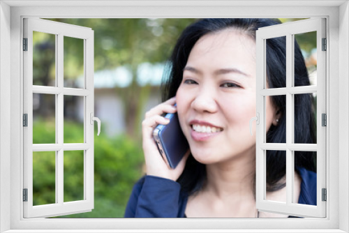 Asian woman talking on smart phone at park. Communication concept. Extrovert characteristic. chit chat with friend.