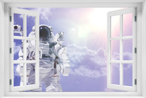 Fototapeta Naklejka Na Ścianę Okno 3D - creative concept of happy astronaut fly high in the sky with clouds, relax chill and dream idea elements of this image furnished by nasa