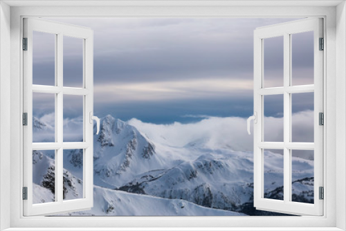 Fototapeta Naklejka Na Ścianę Okno 3D - Whistler, British Columbia, Canada. Beautiful Panoramic View of the Canadian Snow Covered Mountain Landscape during a cloudy and vibrant winter sunset.
