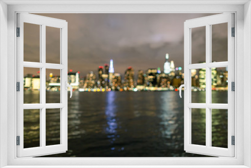 Fototapeta Naklejka Na Ścianę Okno 3D - Blurred midtown Manhattan at night From East river