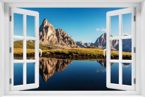 Fototapeta Naklejka Na Ścianę Okno 3D - Incredible nature landscape. famous Ra Gusela under sunlight. Beautiful view of Giau Pass, Italian Dolomites, with the peaks of teh mountain reflected in a small lake, Awesome natural Background.