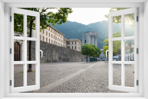 Fototapeta Naklejka Na Ścianę Okno 3D - Como city, historic center, lake Como, Italy. Scenic view of the old walls with the medieval tower called of San Vitale (viale Battisti). Itinerary and travel destination in northern Italy 