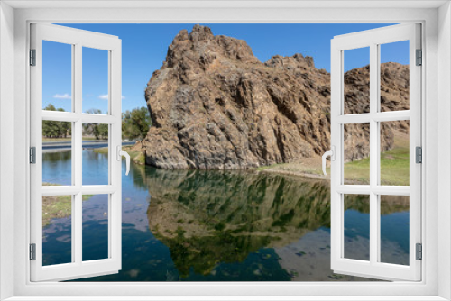 Fototapeta Naklejka Na Ścianę Okno 3D - rock reflected in a small lake in central Mongolia. reflection of the stone. The beautiful landscape of Mongolia. Sunny day in autumn, blue clear sky. Mirroring of the sky in the crystal clear water