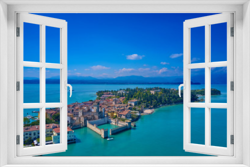 Fototapeta Naklejka Na Ścianę Okno 3D - Unique view. Aerial photography, the city of Sirmione on Lake Garda north of Italy. In the background is the Alps. Resort place. Aerial view. Sirmione Castle,