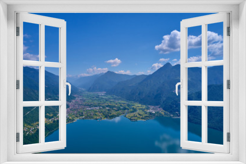 Fototapeta Naklejka Na Ścianę Okno 3D - Panoramic view of the mountains and Lake Idro.  Reflection in the water of the mountains, trees, blue sky. Aerial view, drone photo