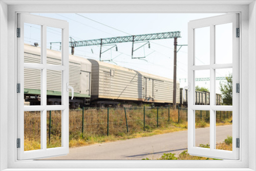 Fototapeta Naklejka Na Ścianę Okno 3D - Coal railroad cars and speed train in motion