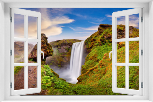 Fototapeta Naklejka Na Ścianę Okno 3D - Panoramic view of Skogafoss waterfall on the Skoga river, a popular tourist attraction and part of the Golden Circle Tourist Route. Famous landmark of Iceland, Europe. Travelling concept background.