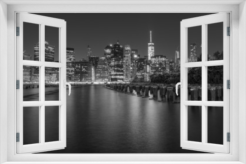 Fototapeta Naklejka Na Ścianę Okno 3D - Dramatic, black and white New York City skyline from Brooklyn Bridge Park at night.