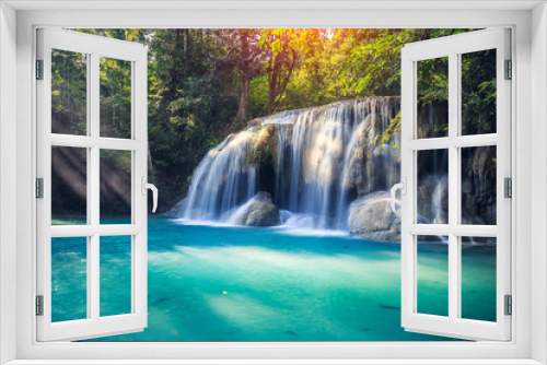 Fototapeta Naklejka Na Ścianę Okno 3D - Waterfall, green forest in Erawan National Park, Thailand. Landscape with water flow, river, stream and rock at outdoor. Beautiful scenery of nature for tourist to tour, visit, relax in vacation.