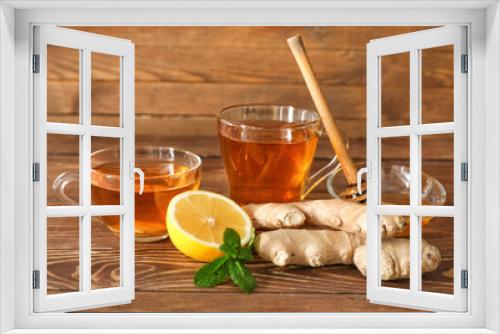 Fototapeta Naklejka Na Ścianę Okno 3D - Cups of healthy drink with lemon, ginger and honey on wooden table