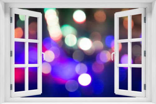 Abstract background with defocused bokeh colorful lights, glowing sparkling lights and reflections