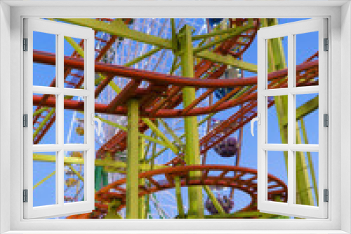 Fototapeta Naklejka Na Ścianę Okno 3D - Roller Coaster in the city amusement park at evening.