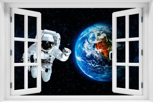 Fototapeta Naklejka Na Ścianę Okno 3D - astronaut flies over the earth in space.