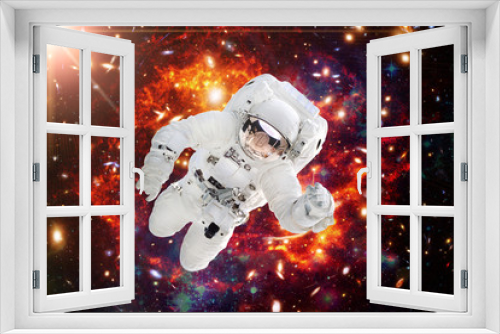 Fototapeta Naklejka Na Ścianę Okno 3D - Astronaut against deep space. The elements of this image furnished by NASA.