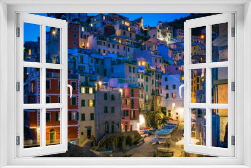 Fototapeta Naklejka Na Ścianę Okno 3D - Colorful photograph of the historic buildings of Riomaggiore, Italy lit up at night