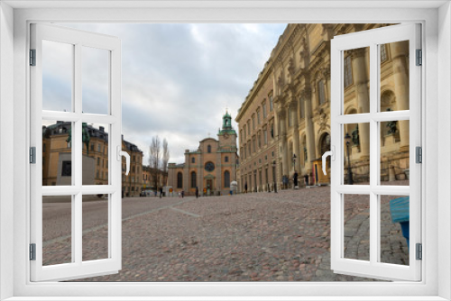 Fototapeta Naklejka Na Ścianę Okno 3D - Street in front of the Stockholm Royal Palace - the official residence of the Swedish monarchs on the main promenade of the island of Stadholmen in the center of Stockholm.