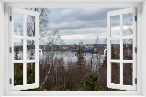 Fototapeta Naklejka Na Ścianę Okno 3D - View from the shore of the bay to the ancient city of Vyborg and the port on a cloudy spring day
