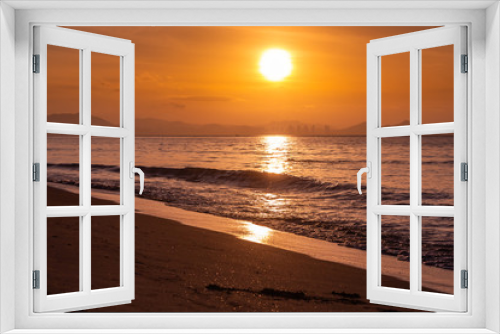 Fototapeta Naklejka Na Ścianę Okno 3D - Beautiful orange sunrise is on the beach by the sea