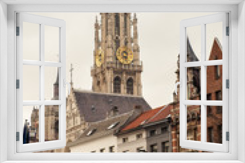 Fototapeta Naklejka Na Ścianę Okno 3D - Vertical view of bell tower of Cathedral of Our Lady in Antwerp, UNESCO world heritage site in Belgium with flemish houses around. Popular travel tourism destination in Benelux