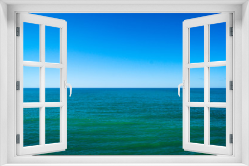 Fototapeta Naklejka Na Ścianę Okno 3D - Calm sea and blue sky, horizontal photo. The horizon line divides the photo in half