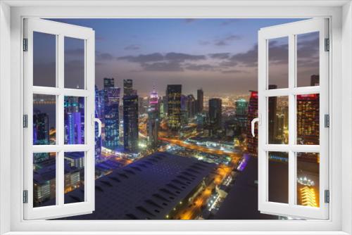 Fototapeta Naklejka Na Ścianę Okno 3D - The skyline of the West Bay area from top in Doha day to night timelapse, Qatar.