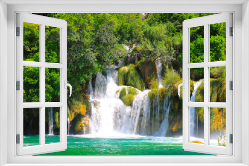 Fototapeta Naklejka Na Ścianę Okno 3D - A picturesque cascade waterfall among large stones in the Krka National Landscape Park, Croatia in spring or summer. The beautiful Croatian waterfalls, mountains and nature.