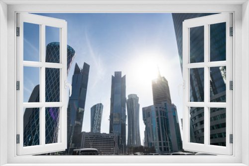 Fototapeta Naklejka Na Ścianę Okno 3D - Modern city center with Towers and skyscrapers on sunny sky background. Doha, Qatar 2020