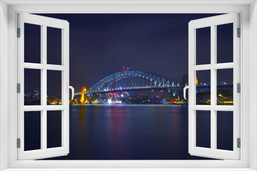 Fototapeta Naklejka Na Ścianę Okno 3D - Sydney Harbour Bridge illuminating the harbour and circular quay with vibrant colourful lights at midnight in NSW Australia